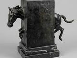 an image of a statue of a horse jumping over a pillar