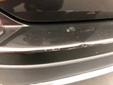 the front bumper of a car with a denting dent on it