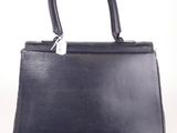 a black leather handbag on a white background