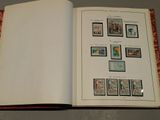 an open book with stamps on it sitting on a table