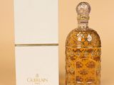 an image of a bottle of perfume sitting next to a box