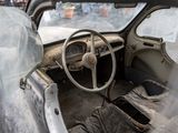 an old car that is sitting in the street