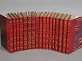 several red books are lined up in a row on a table