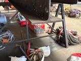 an image of a man working on a boat in a garage