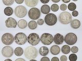 a collection of silver and silver coins from around the world