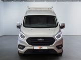 the front of a silver ford transit van parked in a garage