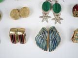 many different types of jewelry on a white surface