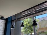three lights hanging from the ceiling of a restaurant