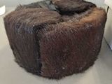 a piece of chocolate cake on display in a glass case