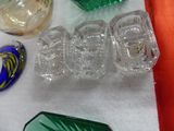 many different colored glass items on the table