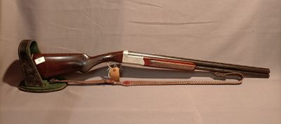 a gun that is sitting on a table next to a pair of scissors