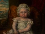 portrait of a child in a white dress sitting on a red chair