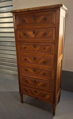 an old wooden chest of drawers in a room next to a wall