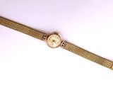 a close up of a wrist watch on a white surface
