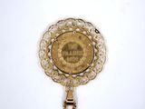 an image of a gold coin with a chain hanging from it ' s side