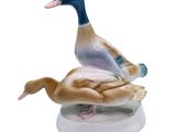 a figurine of two ducks sitting on top of each other