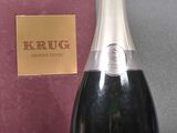 a bottle of champagne sitting next to a pink box
