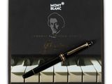a black pen sitting on top of a piano keyboard next to a notepad