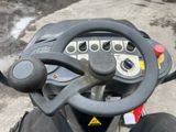 a close up of a steering wheel on a small vehicle
