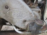 a close up of a motorcycle with a rusted engine