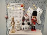 a christmas display with a snowman, a nutcracker and a christmas stocking