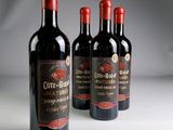 three bottles of wine sitting on top of a table next to each other