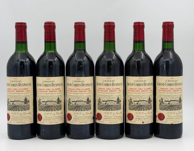 six bottles of red wine are lined up in a row