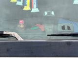 a picture of a car window with a bunch of items on it