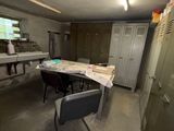 a room with a table and a chair in it