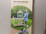 a cardboard box with a picture of a child playing in it