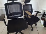 une chaise de bureau noire et une chaise de bureau noire dans une pièce
