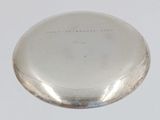 an antique silver pocket watch on a white surface with a white background