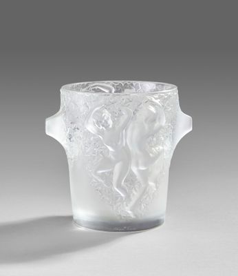 a glass vase with a design on it on a table
