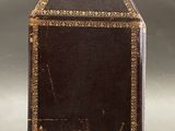 an old black and gold box with a picture of a man in a hat