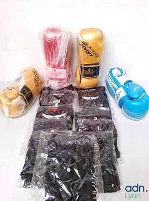 bags of boxing gloves, gloves, and other items are on a table