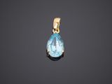 an aqua blue topaze tear shaped pendant on a black background