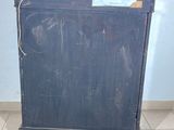a black cabinet that is on the floor in a room