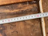 a measuring tape on a piece of wood that is being used to measure the width of a piece of wood
