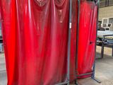 a room with a red curtain in it and a table in the background