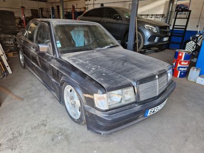 a picture of a car in a garage with other cars in the background