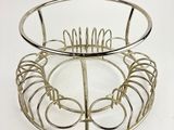 a metal basket with a wire design on top of it