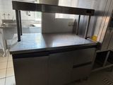 a large kitchen with stainless steel appliances and counters