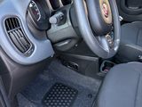 the interior of a small car with a steering wheel and dashboard