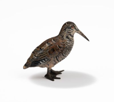 a small bird that is standing on a white surface