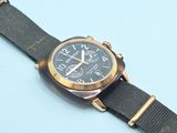 a watch that is sitting on top of a blue surface