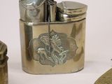 a silver lighter that is sitting next to some other items