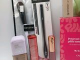 a box of makeup and a brush sitting on a table