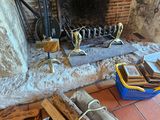 a fire place with a firewood and a bucket on the floor