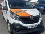 a white van with an orange stripe parked in a parking lot