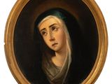 an oval portrait of a woman in a green head scarf